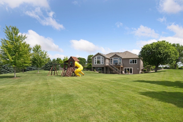 9015 Schutte Ct, Corcoran, MN 55340 - view of grassy yard featuring a playground, stairway, and a deck