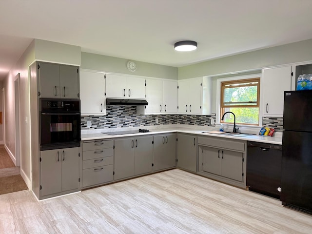 17535 Riverwood Dr, Little Falls, MN 56345 - kitchen featuring black appliances, gray cabinetry, under cabinet range hood, and tasteful backsplash