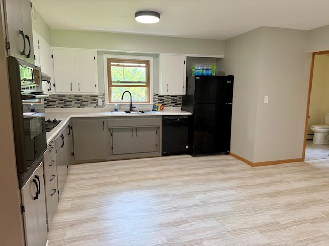 17535 Riverwood Dr, Little Falls, MN 56345 - kitchen with black appliances, backsplash, light countertops, and white cabinetry