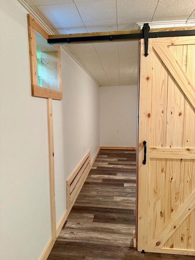 17535 Riverwood Dr, Little Falls, MN 56345 - corridor with a baseboard heating unit, dark wood finished floors, and a barn door
