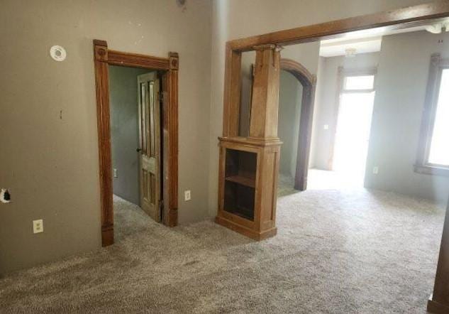 1019 Trott Ave SW, Willmar, MN 56201 - carpeted empty room featuring arched walkways