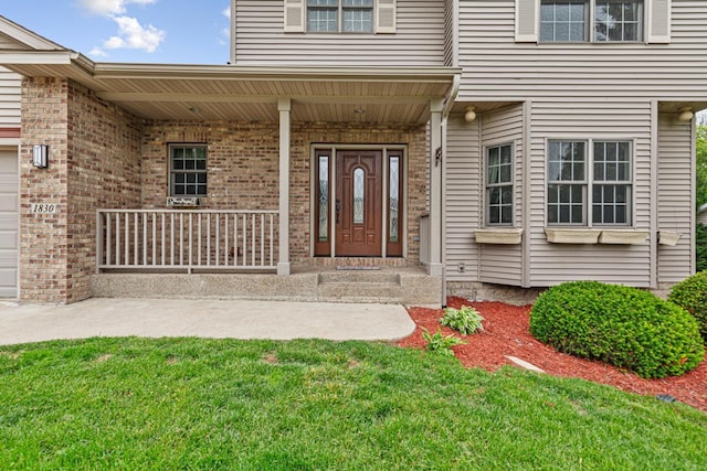 1830 Whitetail Run Pl NE, Owatonna, MN 55060 - entrance to property with a porch, a yard, a garage, and brick siding