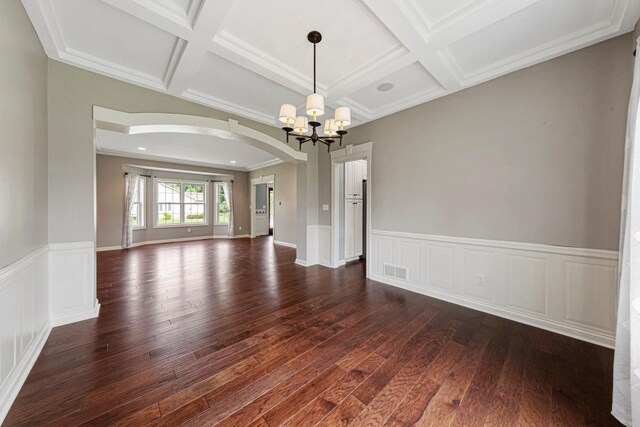 1830 Whitetail Run Pl NE, Owatonna, MN 55060 - empty room featuring arched walkways, a chandelier, dark wood-type flooring, coffered ceiling, and beamed ceiling