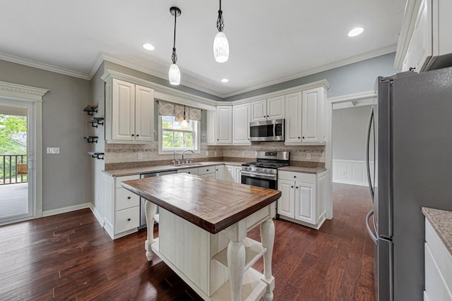 1830 Whitetail Run Pl NE, Owatonna, MN 55060 - kitchen featuring stainless steel appliances, butcher block countertops, crown molding, tasteful backsplash, and white cabinets