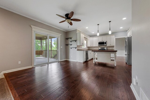 1830 Whitetail Run Pl NE, Owatonna, MN 55060 - kitchen with appliances with stainless steel finishes, dark countertops, ceiling fan, ornamental molding, and dark wood-style floors
