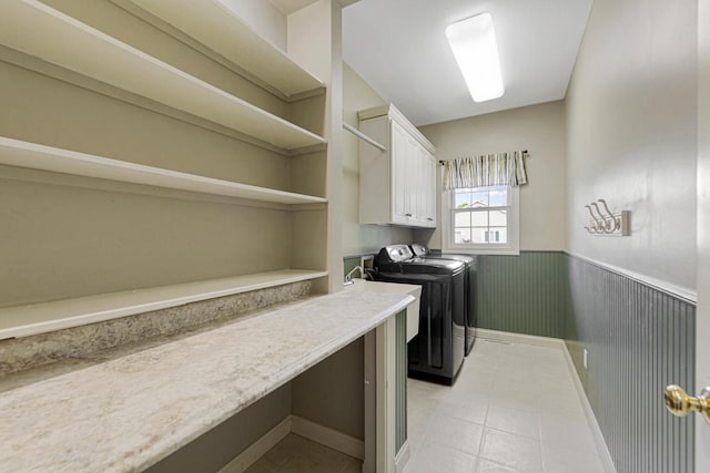 1830 Whitetail Run Pl NE, Owatonna, MN 55060 - laundry area featuring washer and dryer, cabinet space, wainscoting, and light tile patterned floors
