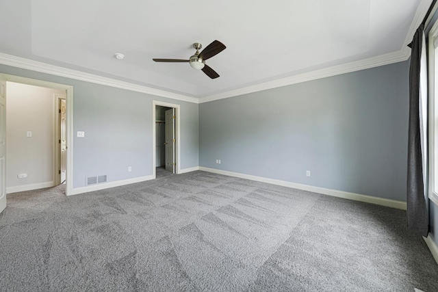 1830 Whitetail Run Pl NE, Owatonna, MN 55060 - unfurnished bedroom with ornamental molding, a walk in closet, a ceiling fan, and carpet