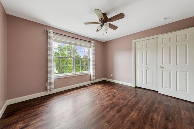 1830 Whitetail Run Pl NE, Owatonna, MN 55060 - unfurnished bedroom with dark wood finished floors, a closet, and a ceiling fan