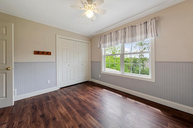 1830 Whitetail Run Pl NE, Owatonna, MN 55060 - unfurnished bedroom with a wainscoted wall, wood finished floors, ornamental molding, a closet, and a ceiling fan