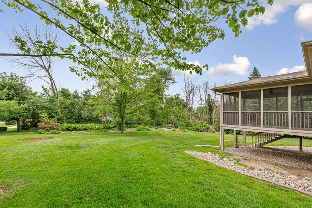 1830 Whitetail Run Pl NE, Owatonna, MN 55060 - view of grassy yard featuring a sunroom and stairs