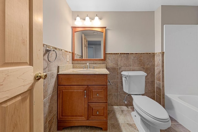 1830 Whitetail Run Pl NE, Owatonna, MN 55060 - full bathroom with tile walls, vanity, a wainscoted wall, and tile patterned floors