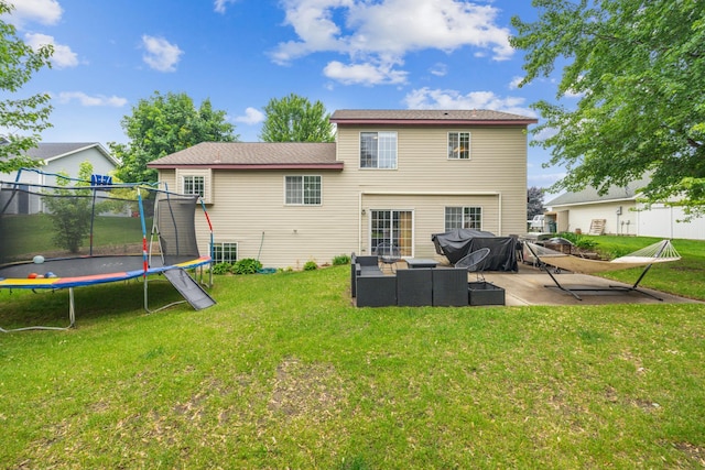 620 Acacia Dr S, Annandale, MN 55302 - back of property with a trampoline, outdoor lounge area, a patio, and a yard