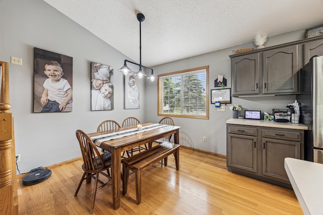 620 Acacia Dr S, Annandale, MN 55302 - dining room with a textured ceiling, light wood-type flooring, and lofted ceiling