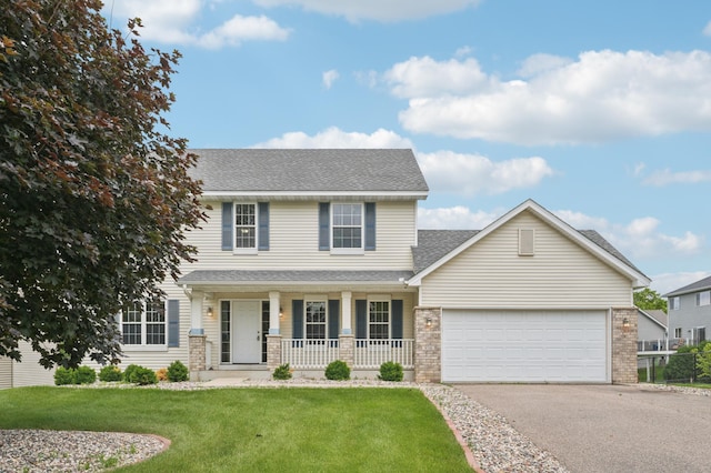 936 Waterford Way, Jordan, MN 55352 - view of front of house with covered porch, asphalt driveway, a front lawn, an attached garage, and roof with shingles