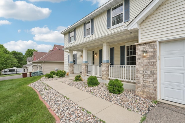 936 Waterford Way, Jordan, MN 55352 - view of front of property with covered porch, a garage, and a front lawn