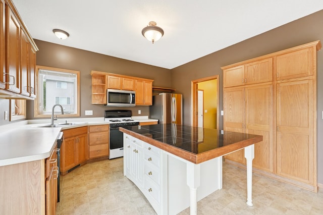936 Waterford Way, Jordan, MN 55352 - kitchen featuring appliances with stainless steel finishes, a kitchen breakfast bar, a kitchen island, open shelves, and tile countertops