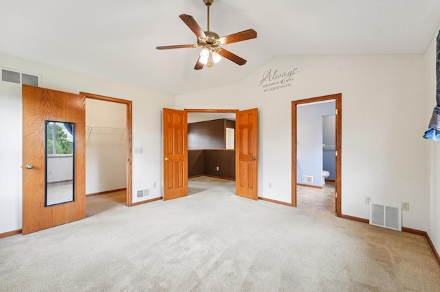 936 Waterford Way, Jordan, MN 55352 - unfurnished bedroom with lofted ceiling, carpet floors, a walk in closet, a closet, and a ceiling fan