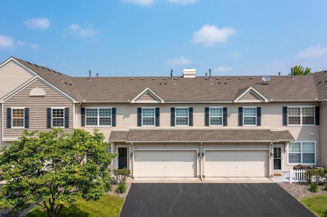 1471 111th Dr NE Unit B, Blaine, MN 55449 - view of property featuring driveway, roof with shingles, a garage, and a chimney