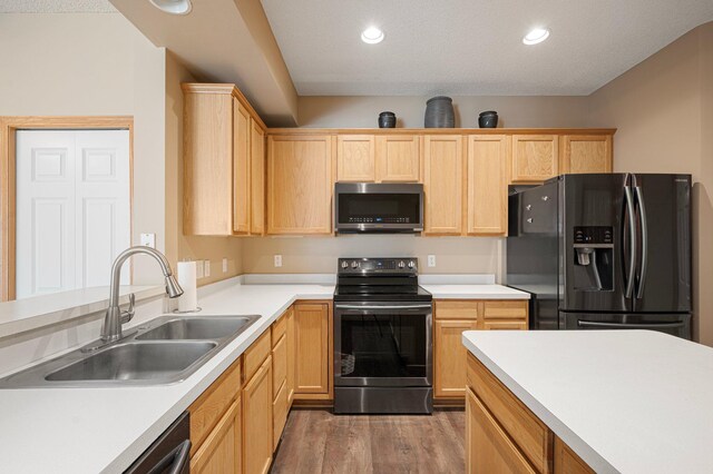 1471 111th Dr NE Unit B, Blaine, MN 55449 - kitchen featuring appliances with stainless steel finishes, light brown cabinetry, light wood-type flooring, light countertops, and recessed lighting