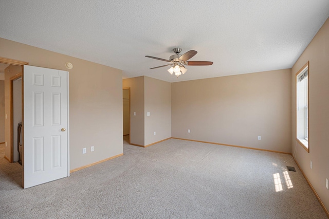 1471 111th Dr NE Unit B, Blaine, MN 55449 - empty room featuring light carpet, a ceiling fan, and a textured ceiling