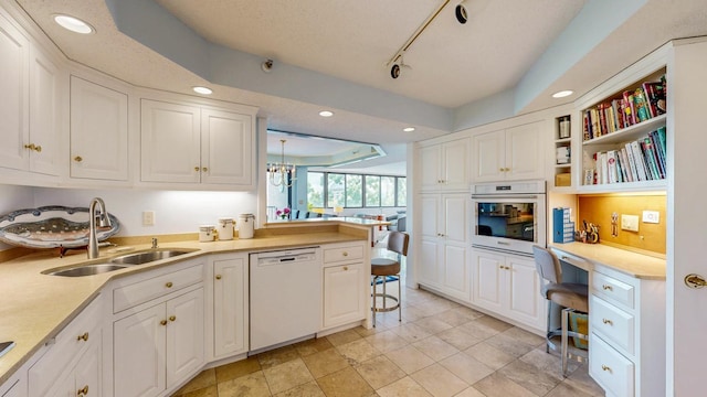 600 4th St SW Unit 401, Rochester, MN 55902 - kitchen with white appliances, built in study area, white cabinetry, and recessed lighting