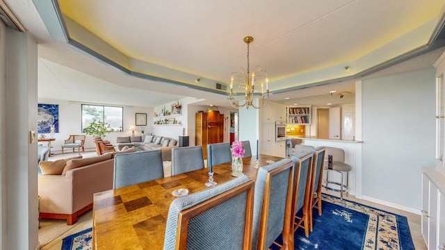 600 4th St SW Unit 401, Rochester, MN 55902 - dining area featuring a chandelier and a tray ceiling