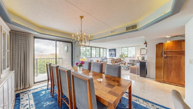 600 4th St SW Unit 401, Rochester, MN 55902 - tiled dining room featuring a chandelier, a textured ceiling, and a tray ceiling