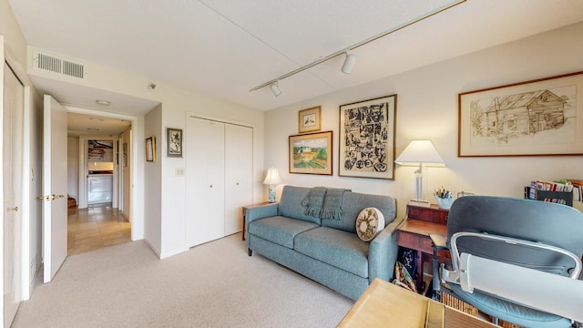600 4th St SW Unit 401, Rochester, MN 55902 - carpeted living room with rail lighting and washer / dryer