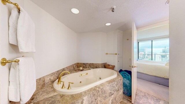600 4th St SW Unit 401, Rochester, MN 55902 - bathroom with a whirlpool tub, connected bathroom, recessed lighting, and a textured ceiling