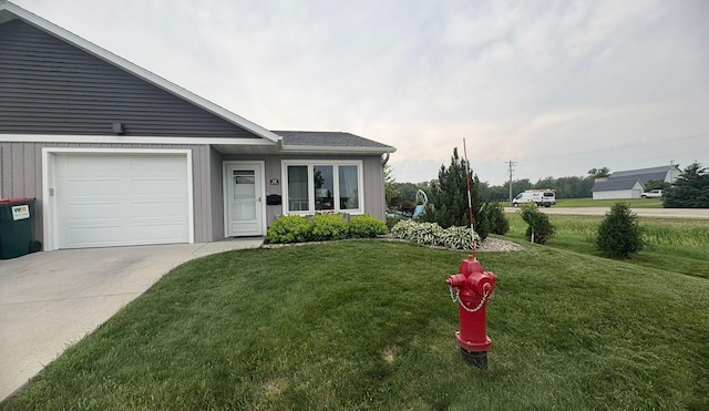 418 Alfred Ct SW, Eyota, MN 55934 - view of front of home with a front lawn, an attached garage, and concrete driveway