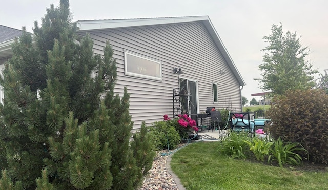 418 Alfred Ct SW, Eyota, MN 55934 - back of house featuring a patio and a lawn