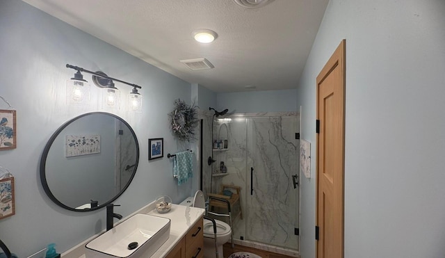 418 Alfred Ct SW, Eyota, MN 55934 - bathroom featuring a marble finish shower, vanity, and a textured ceiling