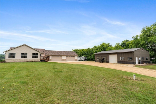 E633 950th Ave, Stanton Twp, WI 54734 - view of green lawn with a garage and dirt driveway