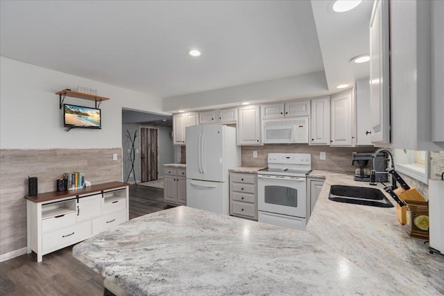E633 950th Ave, Stanton Twp, WI 54734 - kitchen featuring white appliances, a peninsula, light stone counters, recessed lighting, and dark wood-style floors
