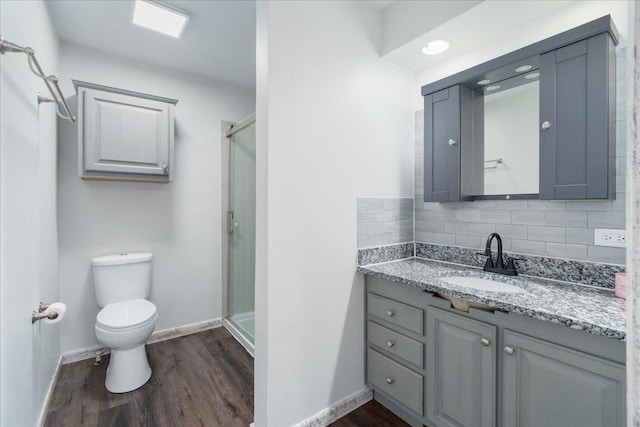 E633 950th Ave, Stanton Twp, WI 54734 - full bathroom featuring wood finished floors, a shower stall, vanity, and tasteful backsplash