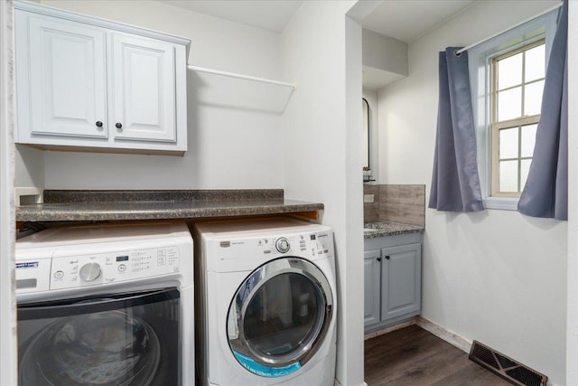 E633 950th Ave, Stanton Twp, WI 54734 - laundry area with washing machine and dryer, dark wood-style floors, and cabinet space