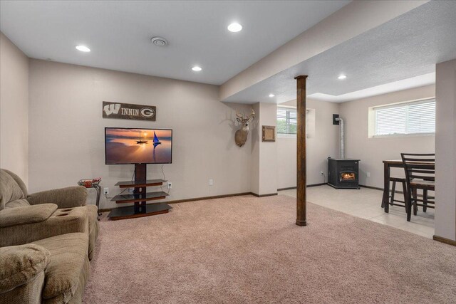 E633 950th Ave, Stanton Twp, WI 54734 - living room featuring a wood stove, carpet flooring, and recessed lighting