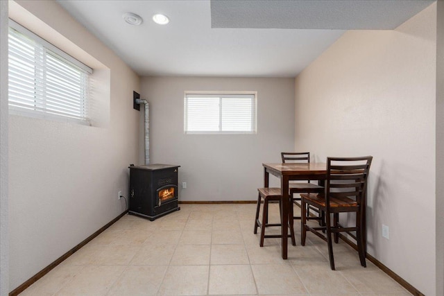 E633 950th Ave, Stanton Twp, WI 54734 - dining area featuring a wood stove and light tile patterned flooring