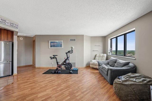 78 10th St E Unit 2901, Saint Paul, MN 55101 - exercise room featuring light wood-style flooring and a textured ceiling