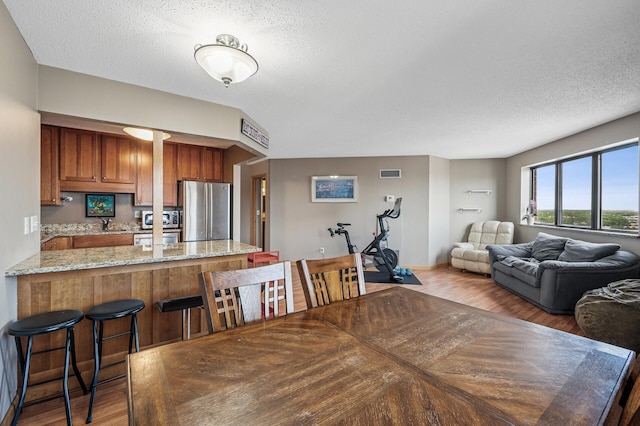 78 10th St E Unit 2901, Saint Paul, MN 55101 - dining space with wood finished floors and a textured ceiling