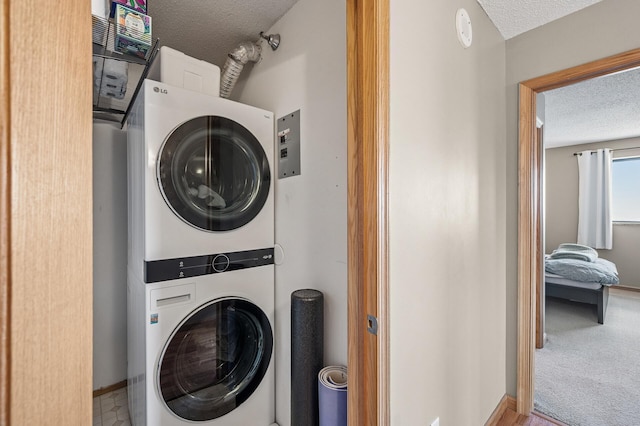 78 10th St E Unit 2901, Saint Paul, MN 55101 - washroom featuring stacked washing machine and dryer and a textured ceiling