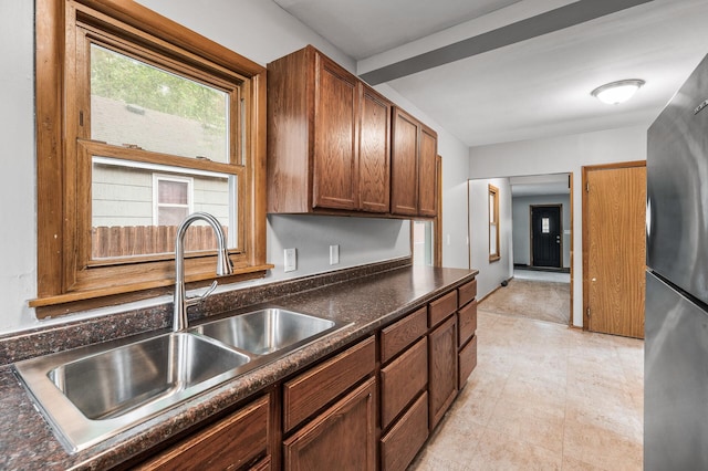 4242 Zane Ave N, Crystal, MN 55422 - kitchen with dark countertops, freestanding refrigerator, and brown cabinets