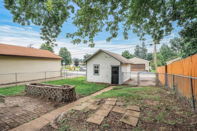 4242 Zane Ave N, Crystal, MN 55422 - fenced backyard featuring a detached garage and an outbuilding