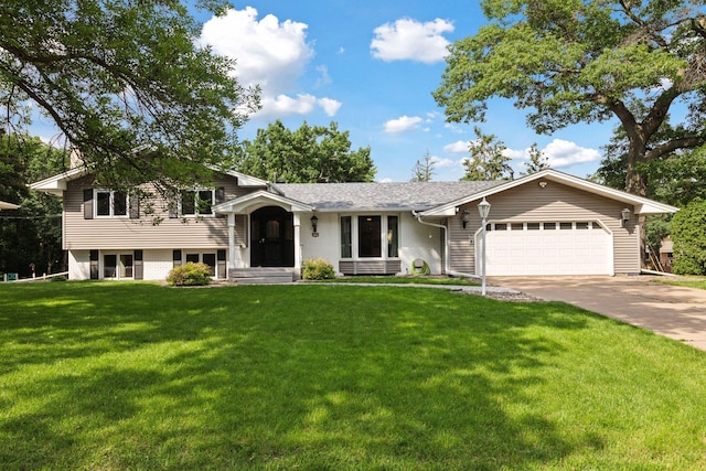 2125 Innsbruck Pkwy, Columbia Heights, MN 55421 - split level home featuring an attached garage, concrete driveway, a front lawn, and brick siding