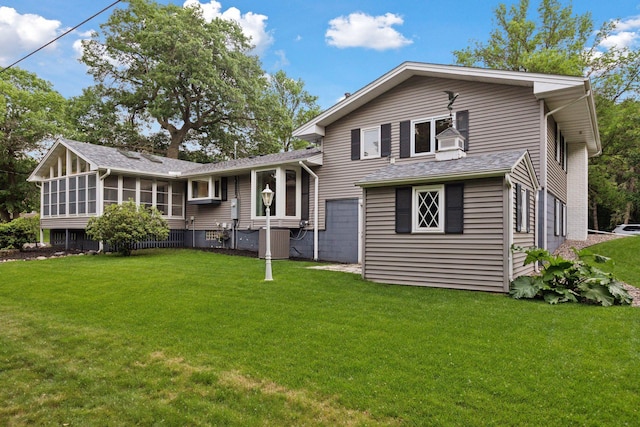 2125 Innsbruck Pkwy, Columbia Heights, MN 55421 - back of house with a sunroom and a yard