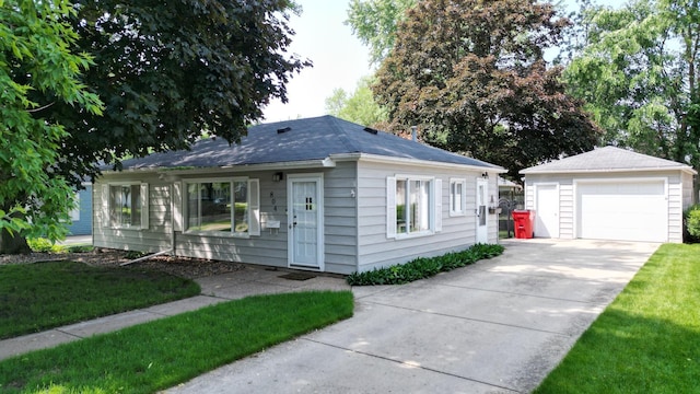 804 17th St SW, Austin, MN 55912 - view of front of property with a garage, an outdoor structure, concrete driveway, and a front yard