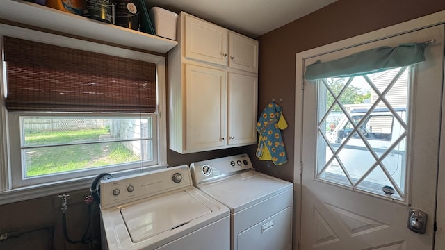 804 17th St SW, Austin, MN 55912 - washroom with washing machine and clothes dryer, cabinet space, and healthy amount of natural light