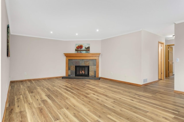 8824 134th St W, Apple Valley, MN 55124 - unfurnished living room featuring light wood-style floors, recessed lighting, ornamental molding, and a tile fireplace