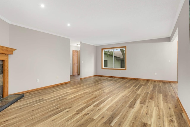 8824 134th St W, Apple Valley, MN 55124 - unfurnished living room with ornamental molding, light wood-type flooring, a glass covered fireplace, and recessed lighting