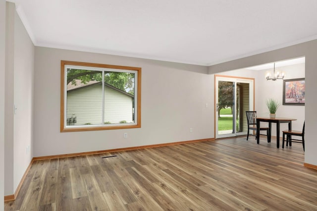8824 134th St W, Apple Valley, MN 55124 - empty room with a chandelier, wood finished floors, and ornamental molding
